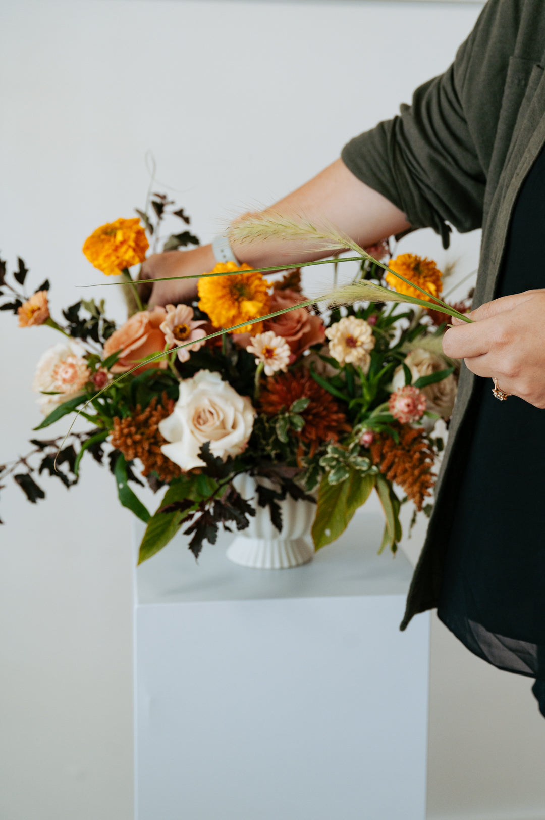 fall themed arrangement set on a white pedestal against a neutral backdrop for pick-up or delivery in central, ohio