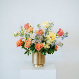 Large april showers arrangement showcasing spring florals set in a gold vase on top of a white pedestal- available for same day pick-up or local delivery in Columbus, Ohio