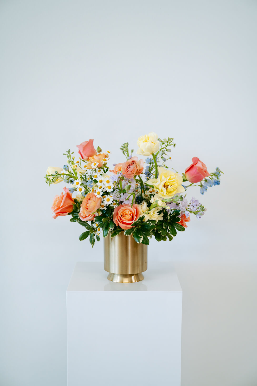 Large april showers arrangement showcasing spring florals set in a gold vase on top of a white pedestal- available for same day pick-up or local delivery in Columbus, Ohio