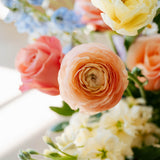 Luxe Grand sized spring flower arrangement set in a white vase on a white pedestal and neutral background. Available for same-day local delivery and pickup in Columbus Ohio 