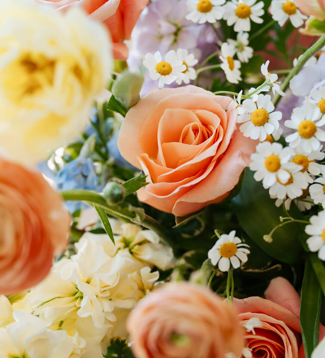 Luxe Grand sized spring flower arrangement close up floral details showing peach ranunculus and roses. Available for same day local delivery and pickup in Columbus Ohio 