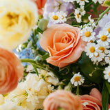 Luxe Grand sized spring flower arrangement close up floral details showing peach ranunculus and roses. Available for same day local delivery and pickup in Columbus Ohio 
