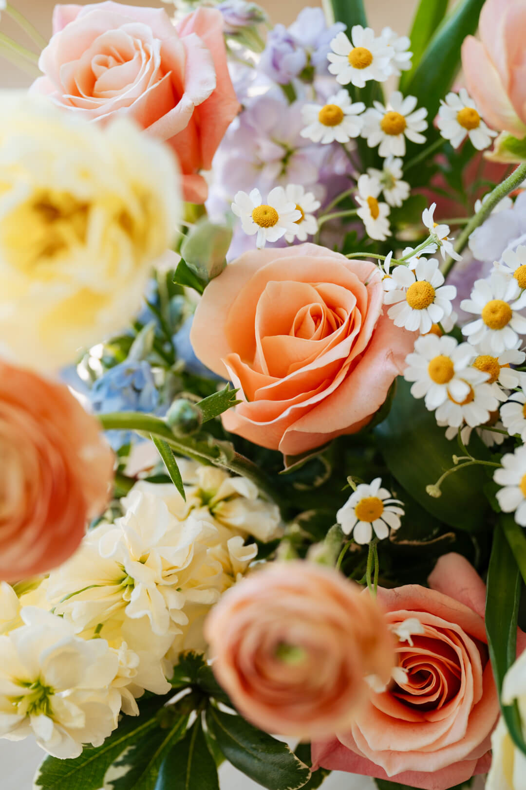 Luxe Grand sized spring flower arrangement close up floral details showing peach ranunculus and roses. Available for same day local delivery and pickup in Columbus Ohio 