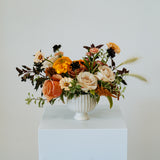 Floral arrangement in a white vase on a pedestal against a plain background available for local delivery and pick-up in Central, Ohio