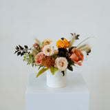 Floral arrangement in a white vase on a light blue pedestal against a white background available for local delivery and pick-up in Central, Ohio