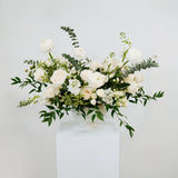Luxe floral arrangement in a white vase on a light gray background