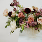 Floral arrangement in a white vase on a light background at Flocal Co.