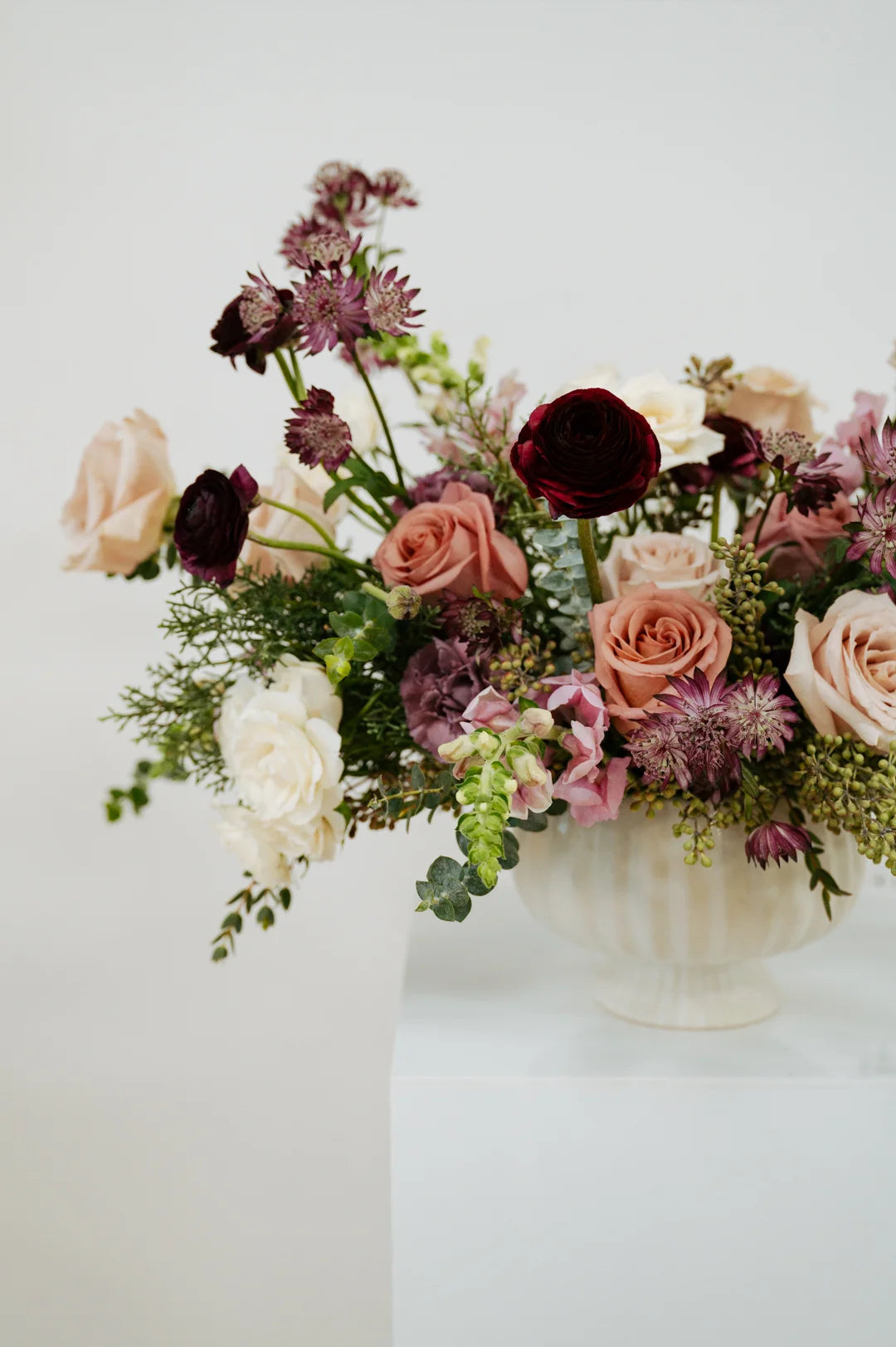 Floral arrangement in a white vase on a light background at Flocal Co.
