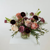 Bouquet of flowers in a clear vase on a white surface in Grandview, Ohio