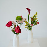 Bud Vase flower arrangement set in a white vase on a white pedestal and neutral background. Available for same day local delivery and pickup in Columbus Ohio 