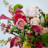 Luxe Grand sized spring flower arrangement set in a white vase on a white pedestal and neutral background. Available for same day local delivery and pickup in Columbus Ohio 