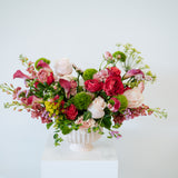 Luxe Grand sized spring flower arrangement set in a white vase on a white pedestal and neutral background. Available for same day local delivery and pickup in Columbus Ohio 